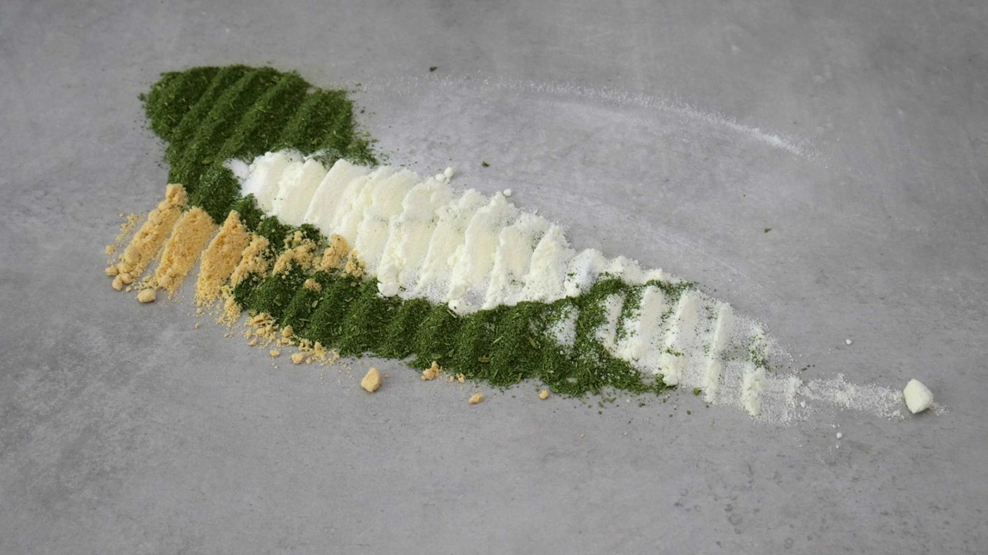 Green, white and yellow powder on table