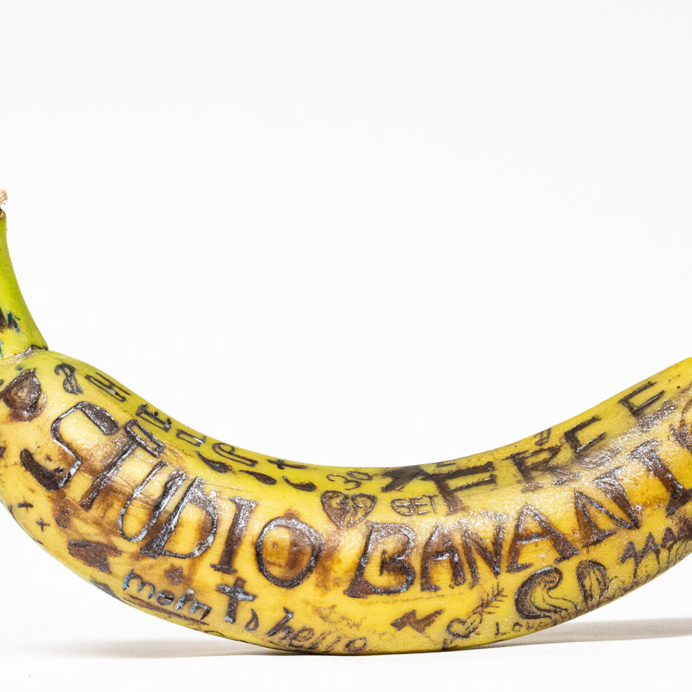 Tattooed banana. Different symbols. Tattowed with the words “Studio Banani” and other words