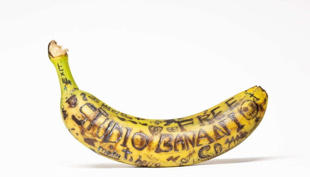 Tattooed banana. Different symbols. Tattowed with the words “Studio Banani” and other words