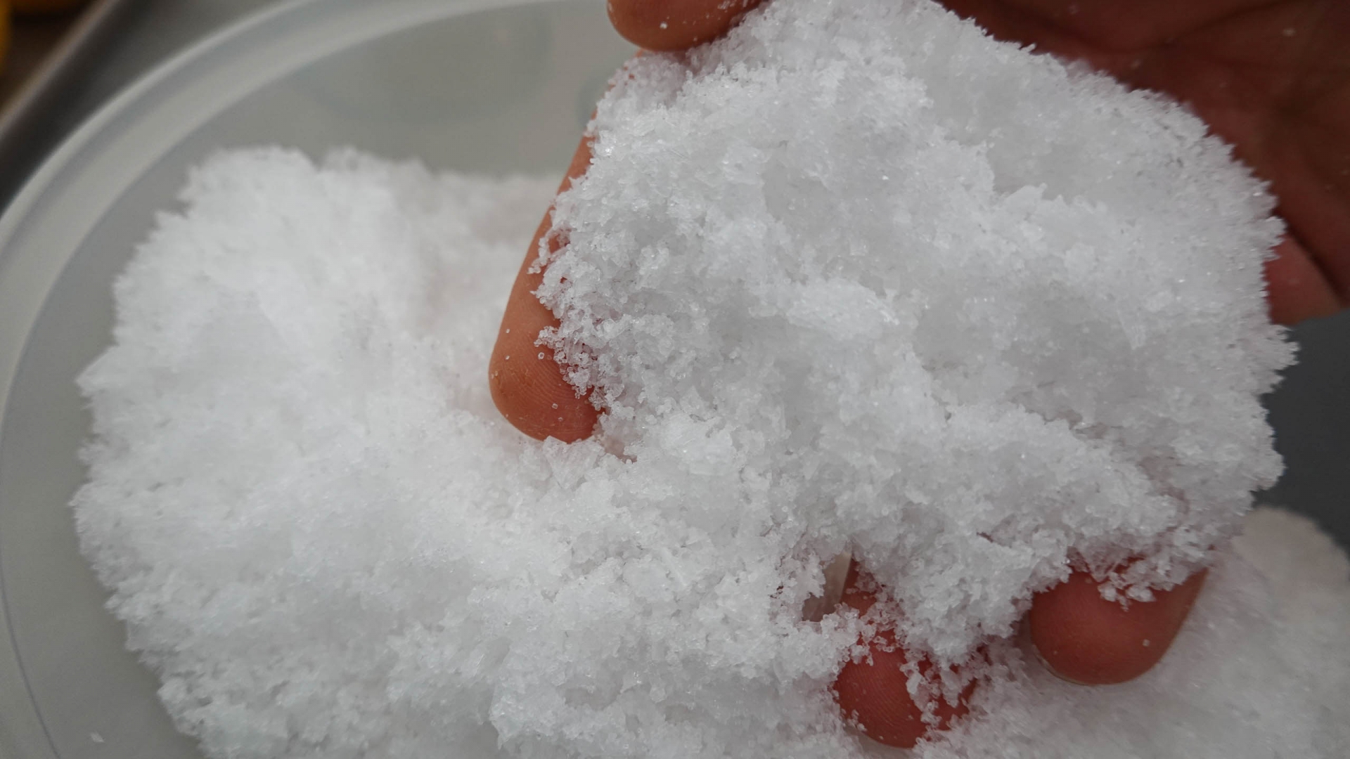 A bowl full of fine sea salt scooped out by hand
