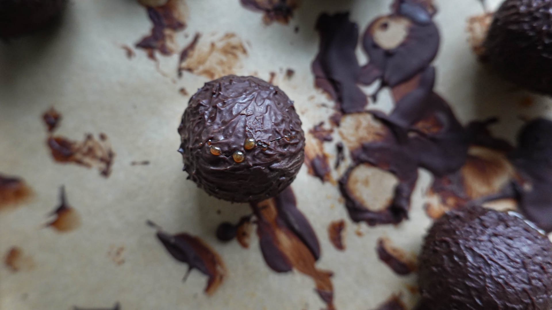 Single chocobon on baking paper full of chocolate remnants